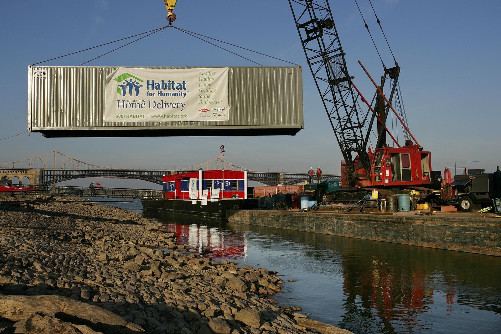 A shipping container, loaded with Habitat for Humanity houses built for Operation Home Delivery, is hoisted onto a barge along the riverfront in St. Louis, Sunday, November 6, 2005. The houses were built during a 40-hour event by volunteers with the St. Louis Habitat affiliate and will be shipped to the Gulf Coast region.(Brian Myrick)