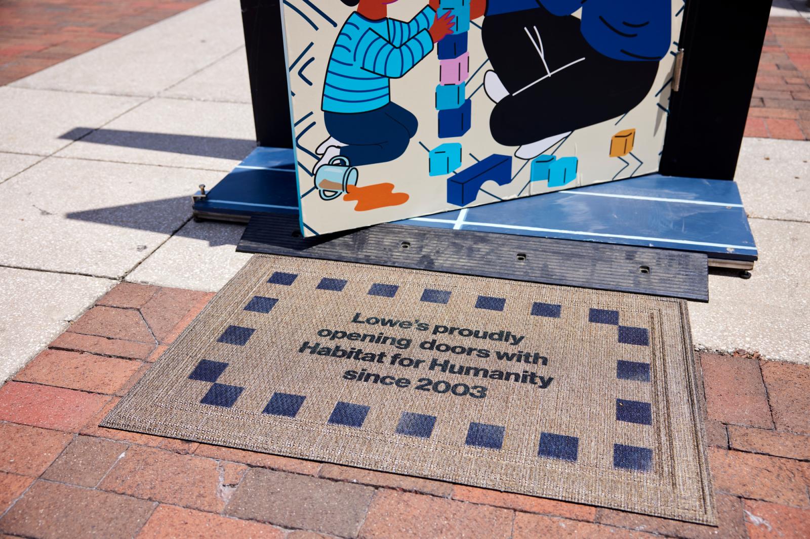 Door mat that says, "Lowes proudly opening doors with Habitat for Humanity since 2003."