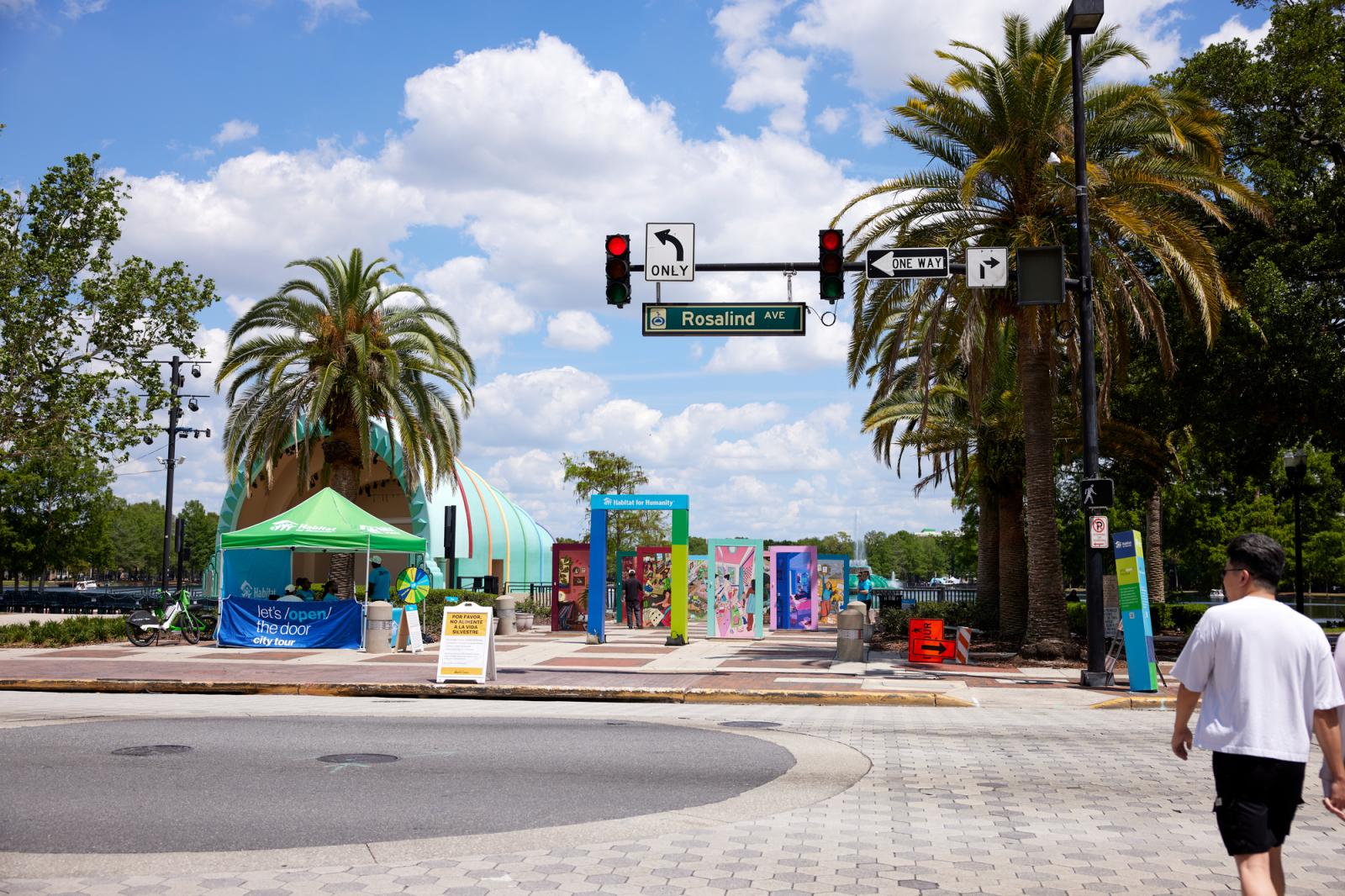 Street view of the LOTD pop-up event in Orlando with doors and palm trees.
