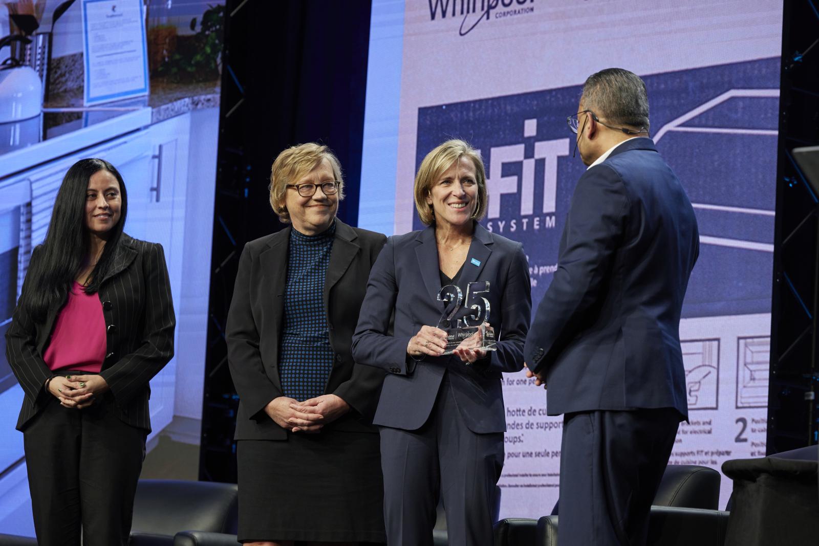Three women and one man on stage.