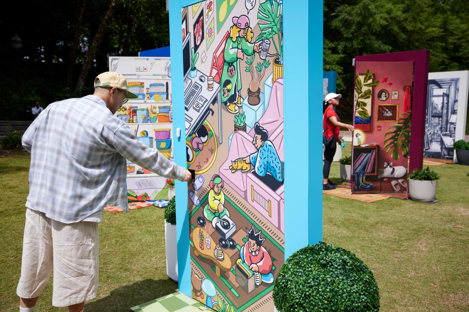 man in checkered shirt and khaki pants pointing images on an illustrated door with a blue frame.