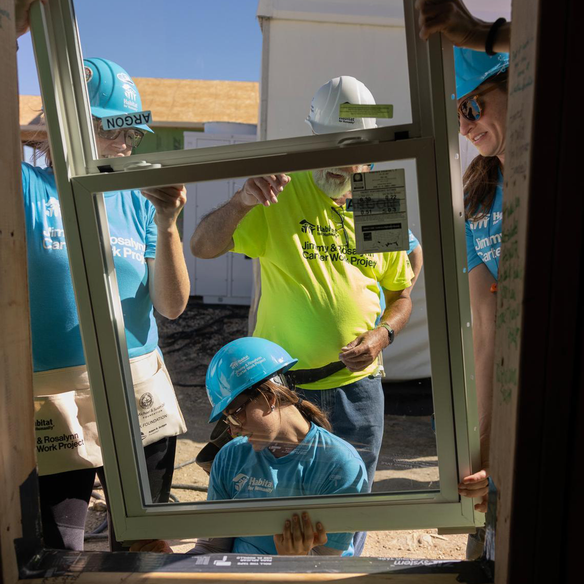 Carter Work Project volunteers installing a window.