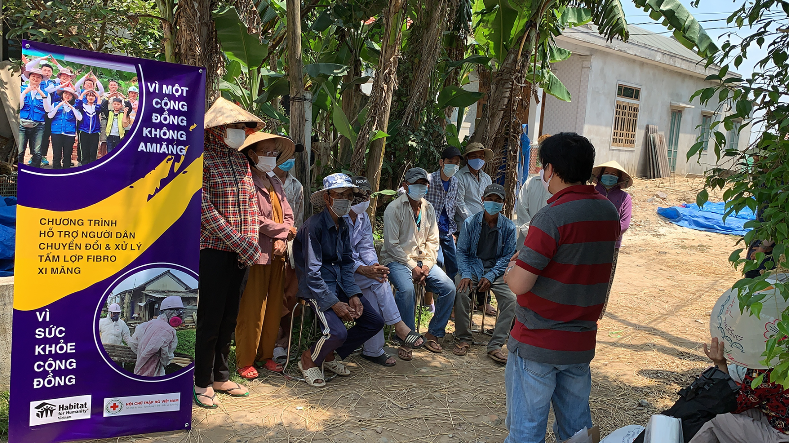 Group of people in a community meeting learning about asbestos risk. 