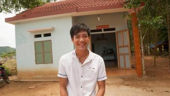 Homeowner in front of Habitat house