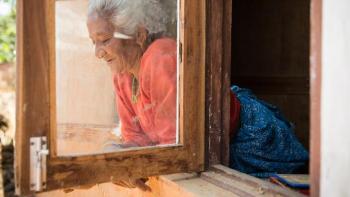 Woman looking out window, Nepal.