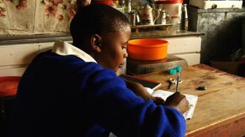 Girl doing homework at her desk in Lesotho