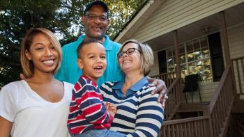 Habitat homeowner family in front of house