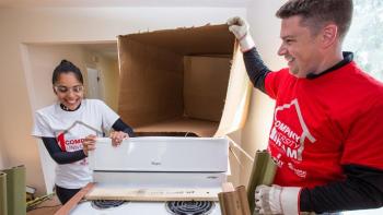 Volunteers open a donated Whirlpool range