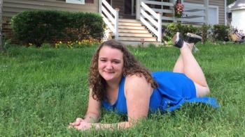 Samantha in front of her Habitat home