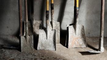 Shovels leaning against a wall