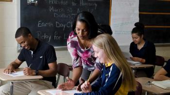 Teacher helping student