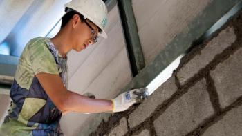 Volunteer laying brick in Thailand Asia-Pacific