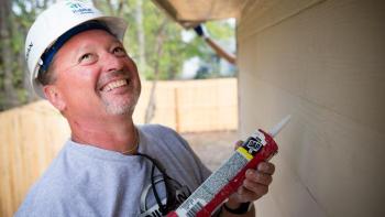 Volunteer lays caulk, DIY home repair and preventive maintenance checklist, Habitat for Humanity