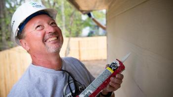 Habitat for Humanity U.S. volunteer caulking a home