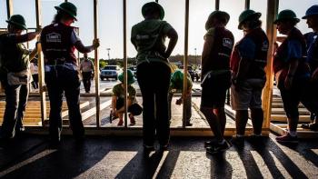 Women Build volunteers raising a wall