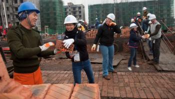 Volunteers laying bricks in China