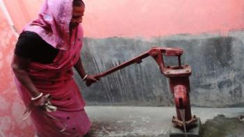 A woman using a water pump. Why is clean water important?