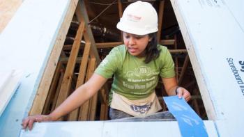 Stories of service, Valerie Nguyen installs a window during the annual Habitat AmeriCorps Build-a-Thon