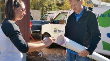 A Habitat volunteer supervising other volunteers