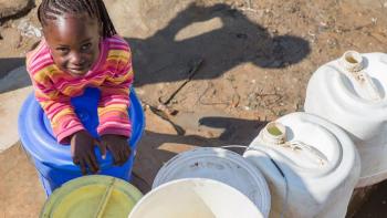 a girl with water tanks in Zambia