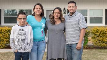 Florida family stands in front of their home. 