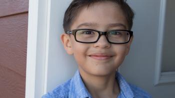 Smiling young boy with glasses