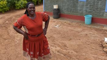 Jane-standing-on-her-own-land-in-front-of-her-own-house