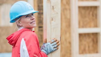 Woman in hard hat on build site
