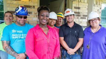 Volunteers in Texas work with a Habitat homeowner. 