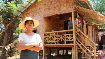 Myint Myint Sein in front of her Habitat bamboo home in Myanmar.