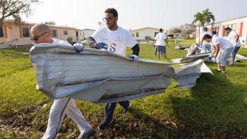 volunteers cleaning up hurricane debris.