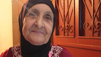 photo: face of a Lebanese woman, light is coming through door behind her 