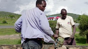Photo: two man building a wall in Kenya