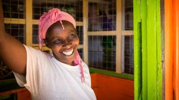 Woman smiles in her home.