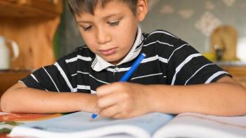 Young boy works on school work.