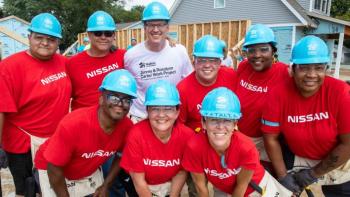 Nissan volunteers with Jonathan Reckford on a build site.