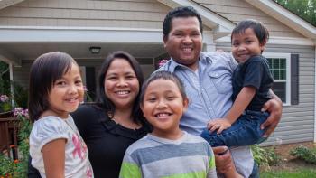 Family outside their home. 