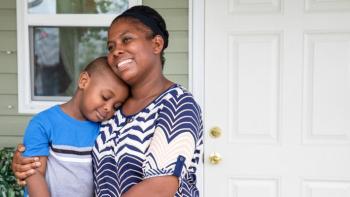 Mother and son hugging.