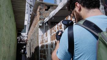 Photo: a cameraman shooting a narrow street