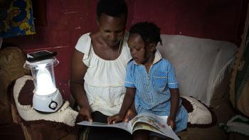 Photo: Mother and daughter reading a book together, Uganda