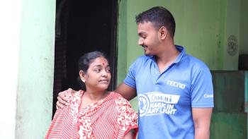 Lalita and her son Biddut in front of their home in Bangladesh.