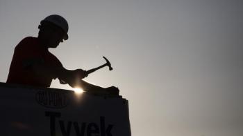 First-time Carter Work Project volunteer Wesley Partin hammers roofing onto a home.