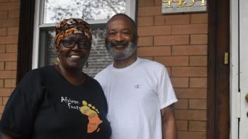 Pat and Reginald in front of their home.