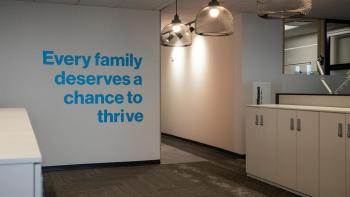 Empty office with the words "Every family deserves the chance to thrive" on the wall.