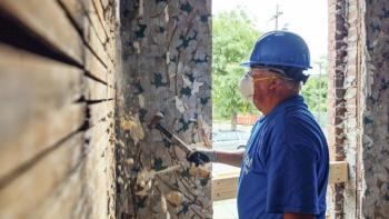 A volunteer wearing a face mask on the build site.