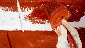 Close-up shot of volunteer's hand painting a wall in Nepal