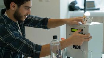 Man demonstrating electronic prototype.