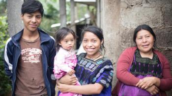 Four members of a family stand together.