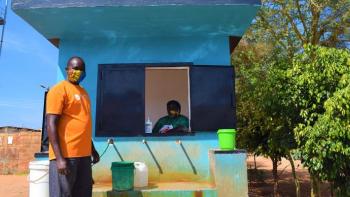 Morrix stands beside a water kiosk.