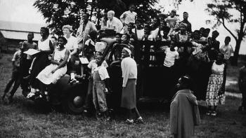 Black and white photo of a group of children on a truck at the Koinonia Farm.